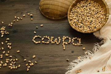 Cowpea bean scattered on the wooden table. Beans  Word "cowpea" in English make up by the beans. 