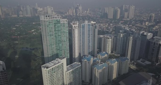Ungraded, Forward aerial flight, Tilt down approaching high rise buildings,  Metropolitan view, Drone, 4K.