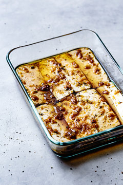 Rows of marinated tofu in a glass dish.