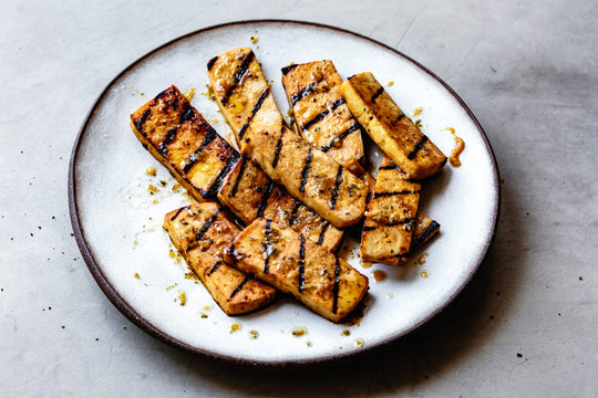 Pieces of grilled marinated tofu.