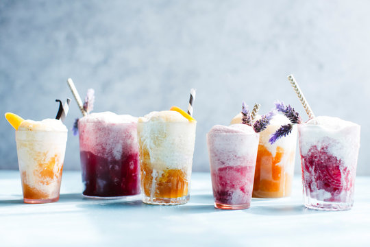 Various Ice cream floats with lavender and straws