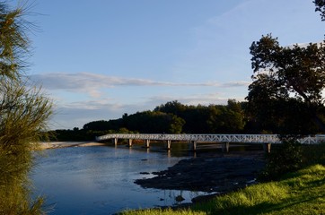 Fototapeta premium A pedestrian bridge over the estuary to Seven Mile Beach at Gerroa, Australia