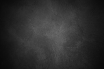 Black concrete background wall. Old surfaces that have scratches and cracks. Black room.	