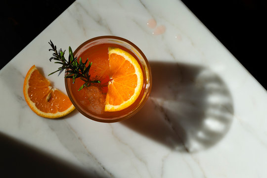 Overhead view of negroni cocktail served on marble table