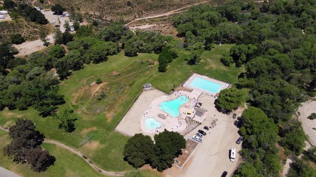 Aerial drone rotation shot over the Vail Lake KOA RV Resort pool area.