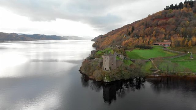Pull back aerial drone shot of Castle on Loch Ness in Inverness, Scotland