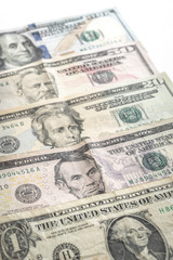 United States paper currency or cash layed fanned out on a table starting with a one dollar bill, five dollar bill, twenty, fifty and hundred making a great economic or business background.