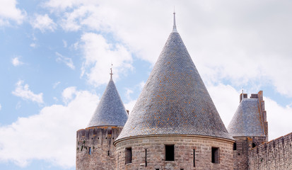 Conical roofs of medieval towers against the sky