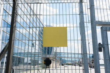 Airport fence grille on the background of passenger bridges for boarding passengers. Place for the test on the plate.