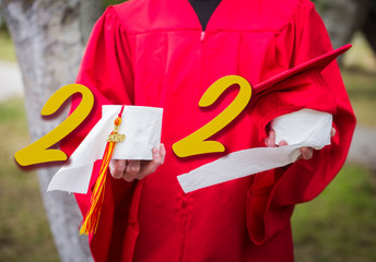 Class of 2020 Senior Graduation during Covid 19 or Corona Senior Graduate holding toilet paper