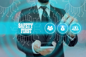 Handwriting text Safety First. Conceptual photo used to say that the most important thing is to be safe © Zofia