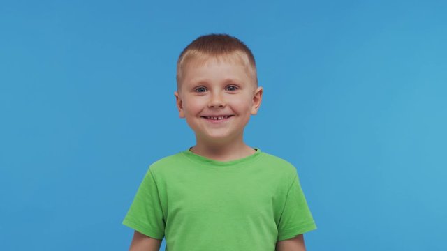 Portrait of happy smiling boy in t-shirt. Attractive and expressive kid in studio.