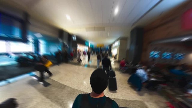 Man walking through busy airport terminal time lapse