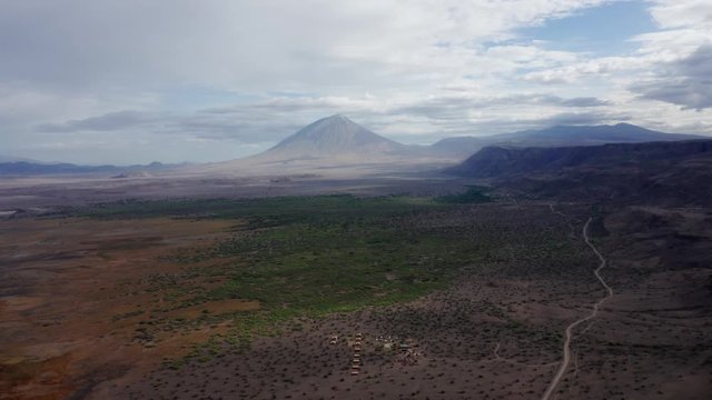 Aerial drone shot flying forward of the landscape of Lake Natron, Tanzania, with a volcano in the end.