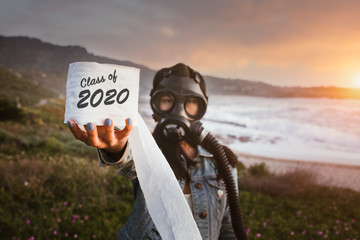 Class of 2020 graduation girl or woman wearing gas mask holding toilet paper during Corona Pandemic or Covid 19