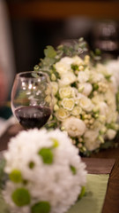 Obraz na płótnie Canvas Glass of red wine with flowers.