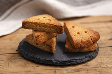 Shortbread biscuit on black stone plate