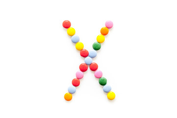 Candies font alphabet. Letter X isolated top view