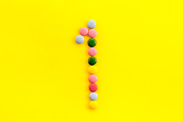 Candies font. Number 1 - one - on yellow background top view