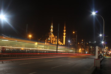 Fototapeta na wymiar Light Trails On Road By Mosque Against Clear Sky At Night