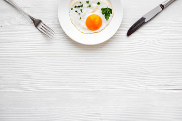 Fried eggs on plate - white background top-down copy space