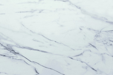 Fototapeta na wymiar Classic white marble background. The marble has grey / black veins running through it