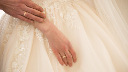 Obraz na płótnie Canvas Hand of the groom on the bride's hand.