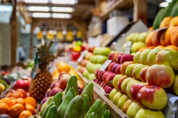 A wooden counter with a variety of ripe fruit on the market. Healthy nutrition, vitamins and vegetarianism.