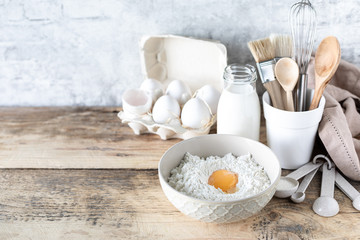 Ingredients for Tiny pancake cereal recipe on a wooden background. Copy space. Place for text.