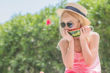 Portrait of a young blonde little girl with watermelon, Summertime fun.