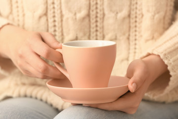 Woman with cup of tea, closeup