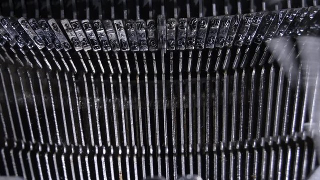 Typo keys of a old qwerty typewriter hitting and writing