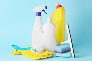 Set of cleaning supplies on color background