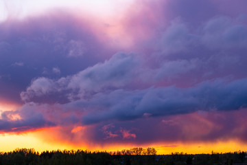 Dramatic thunderstorm clouds at sunset in the Russian village
