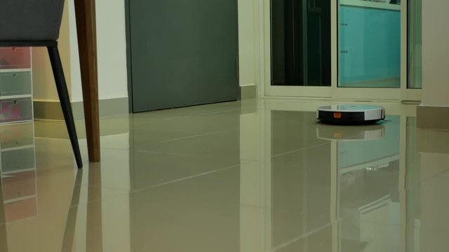 Robotic vacuum cleaner cleaning the floor in the home.