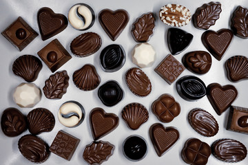 Traditional Turkish Candies designed on black surface with chocolate.Conceptual image of celebrations. Close-up chocolate. Religious Holiday, The Sugar Feast After Ramadan. Top view.

