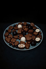 Traditional Turkish Candies designed on black surface with chocolate.Conceptual image of celebrations. Close-up chocolate. Religious Holiday, The Sugar Feast After Ramadan. Top view.
