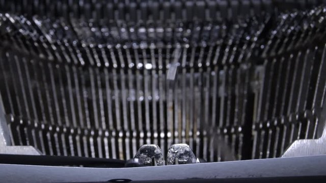 Typo keys of a old manual qwerty typewriter hitting the text