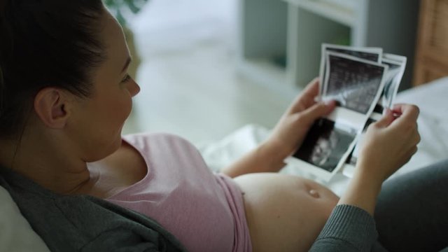 Tracking right video of pregnant woman browsing ultrasound images. Shot with RED helium camera in 8K 