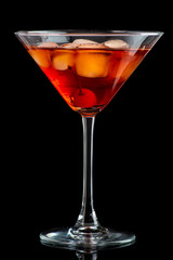 manhattan cocktail in martini glass on dark background