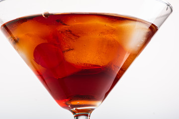 manhattan cocktail in martini glass on white background