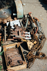 Pile of scrap metal. Rye green pipes. various iron products are in wooden crates. Corrosion on an old satellite dish. Close-up. Macro. Corrosion of metal
