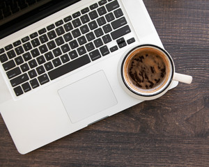 Wooden desk table with computer and hot coffee