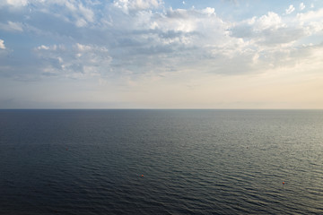 The sea turning into a blue cloudy sky. The skyline divides the photo in half. The Black Sea in a...