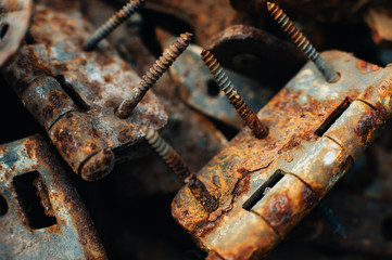 Scrap metal. Rusty screws, latches, curtain. Rust texture. Close-up. Macro. Corrosion of metal