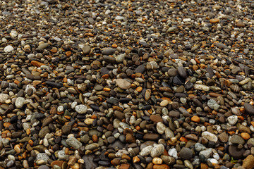 Pebble beach stones on the black sea. Close-up. Isolated. Texture of beach stones.