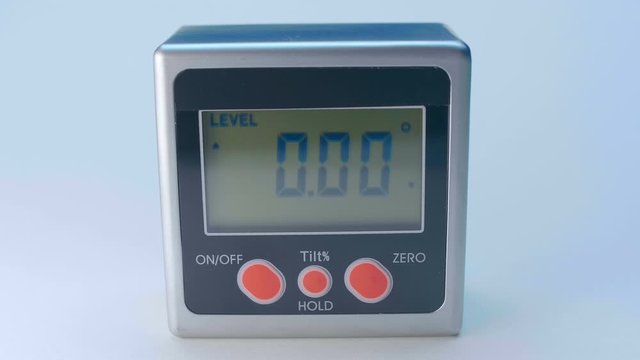 The modern device, which is very necessary in construction and repair - digital magnetic goniometer - measuring the angle of an inclined surface. Macro. Closeup