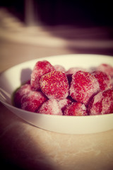 A full plate of strawberries covered in frost