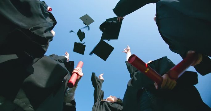 group happy graduates throw caps
