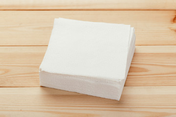 white paper napkin or tissue on the wooden table background.